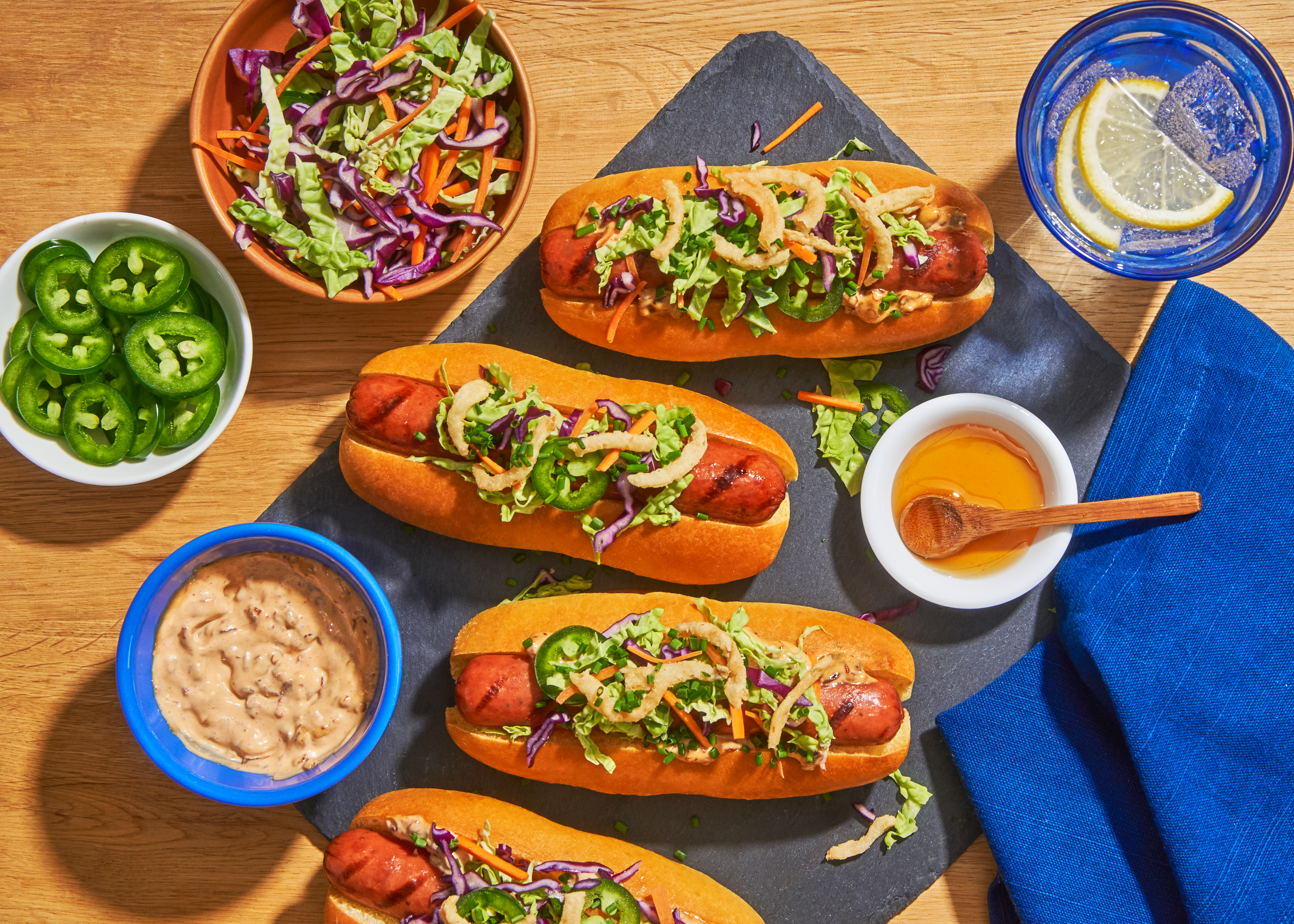Smokey Bacon Cheddar Dogs with Jalapeño Slaw & Chipotle Honey